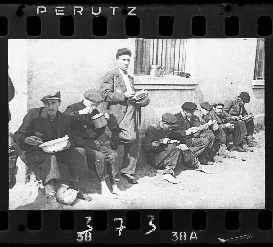 1940-1944: "Soup For Lunch” (Group Of Men Alongside Building Eating From Pails)