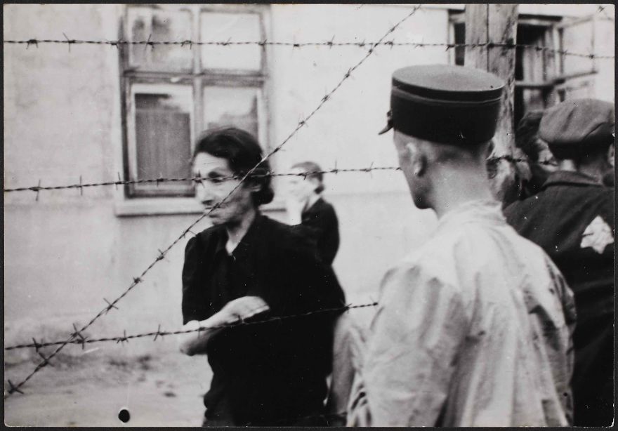 1942: Police With Woman Behind Barbed Wire At The Ghetto