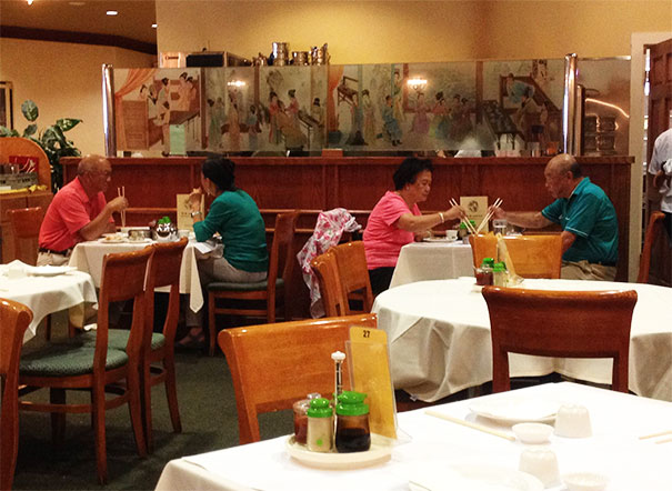 Two couples sitting in the restaurant wearing the same clothes