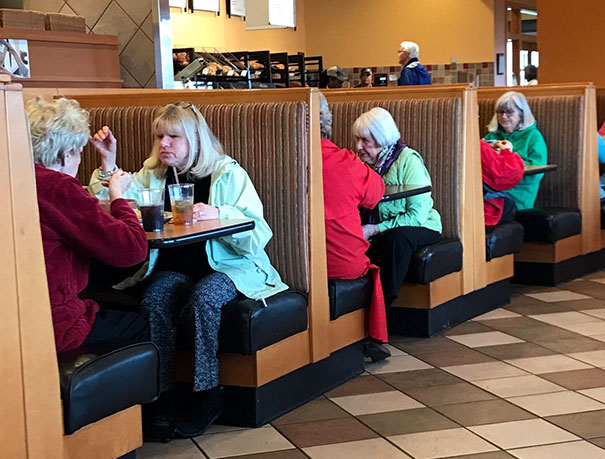 Womens who looks similar sitting in a restaurant
