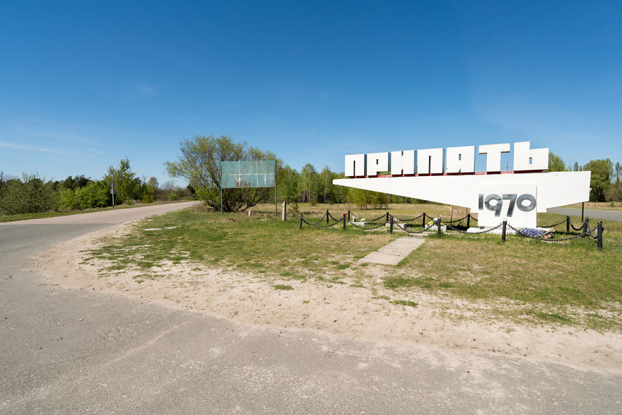 Welcome Sign To Pripyat And The Road Leading Towards It