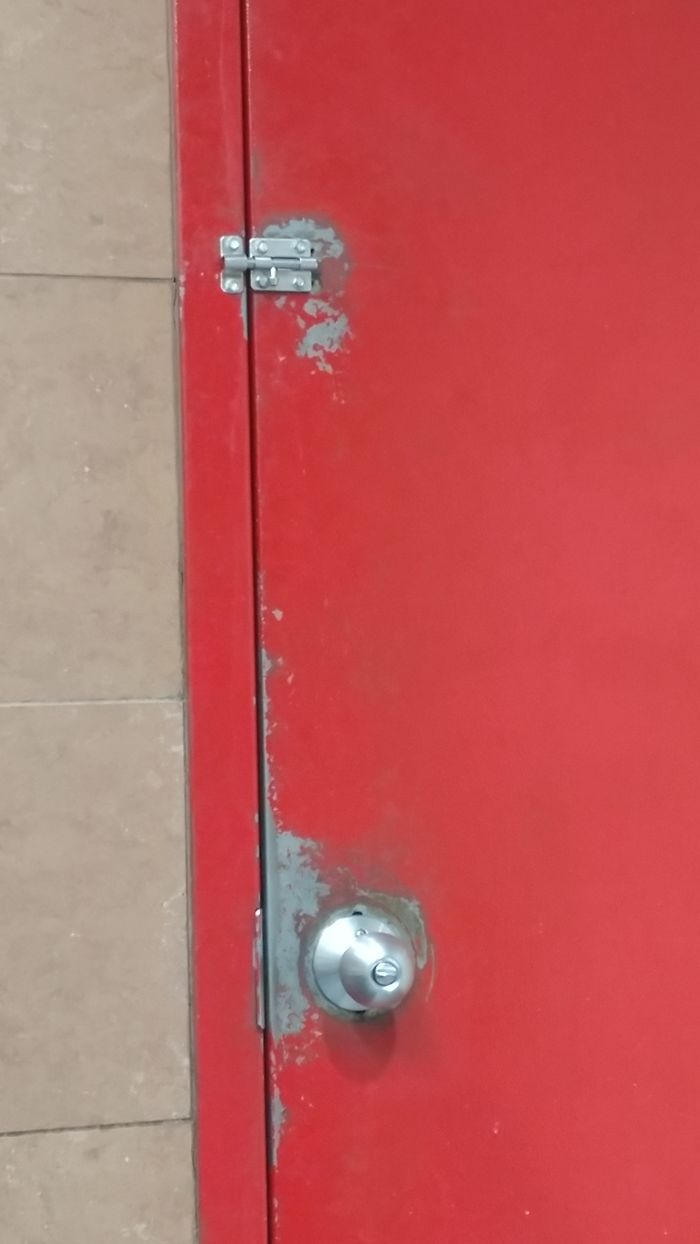 Door Of Bathroom At Truck Stop. Lock And Handle