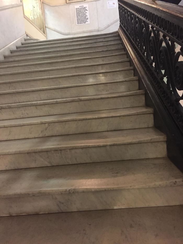 The Marble Steps At My Local Library Are Worn From Use Near The Railing