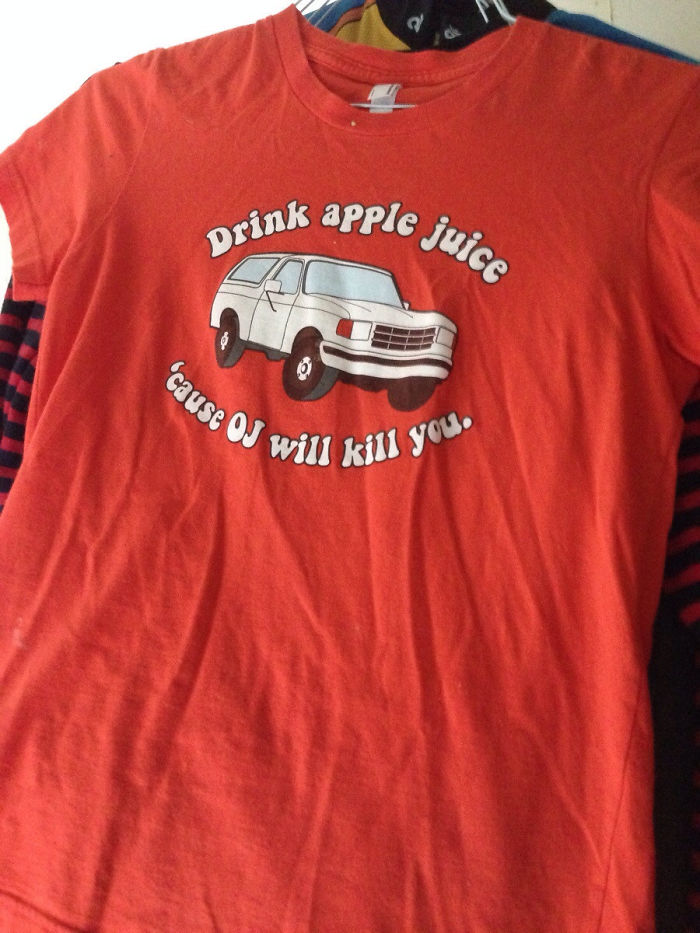 Red thrift store T-shirt with a quirky apple juice slogan and a white van illustration.