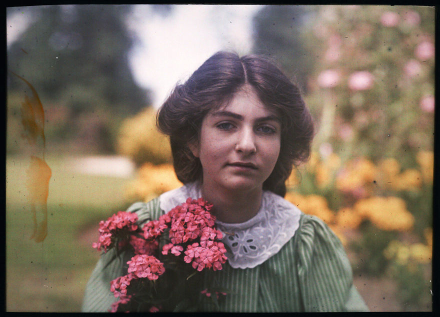 An Autochrome Of Etheldreda Janet Laing Daughter In A Garden, Holding A Brightly Coloured Bunch Of Pink Flowers, 1908