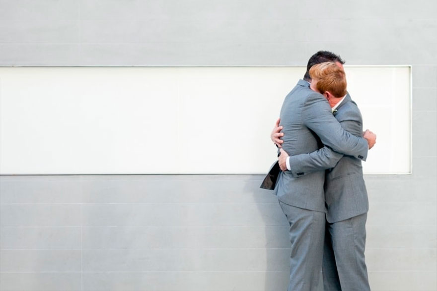 Two men hugging each other 