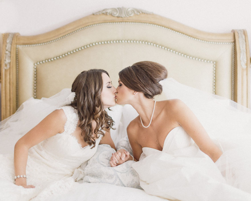 Two women kissing in bed 