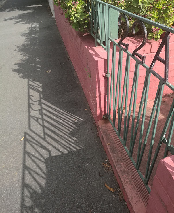 The Shadow Of This Gate Looks Like It Says Ass