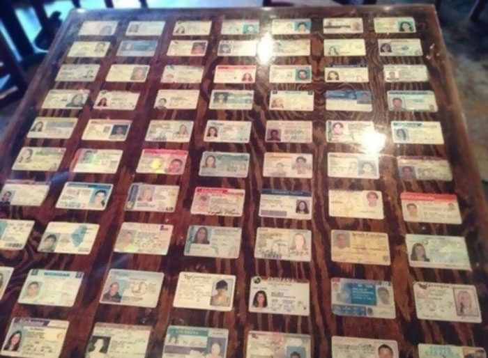 Bar Decorates Their Tables With Seized Fake ID's