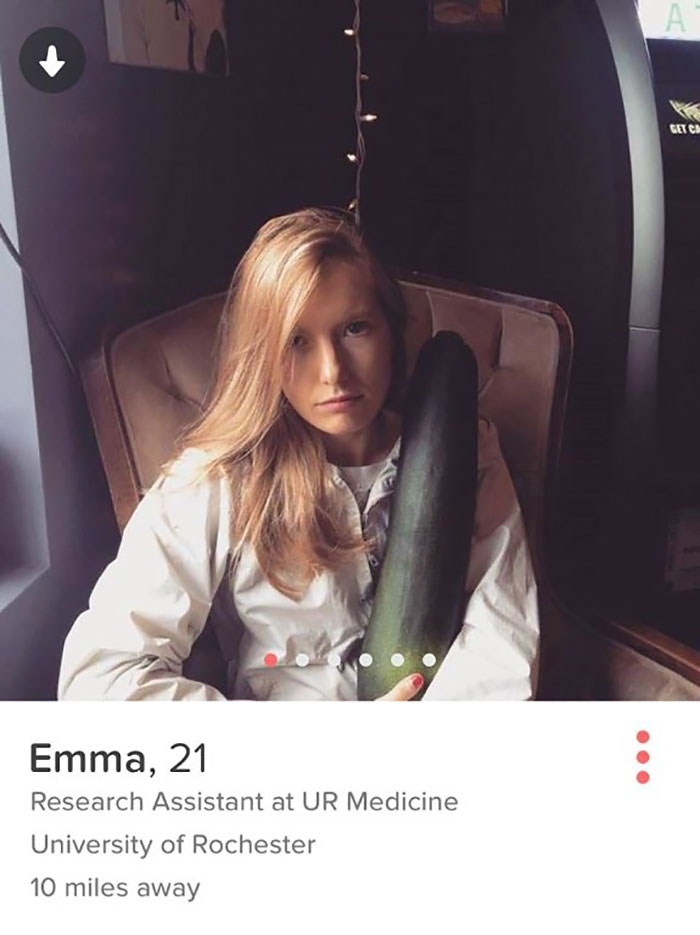 Tinder profile of a woman holding a cucumber 