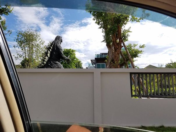 Neighbor Has A Giant Godzilla Statue In His Yard