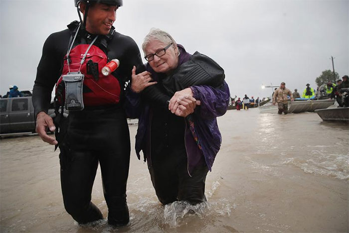Barb Davis, 74. Is Helped To Dry Land After Being Rescued From Her Flooded Neighborhood After It Was Inundated With Rain Water, Remnants Of Hurricane Harvey