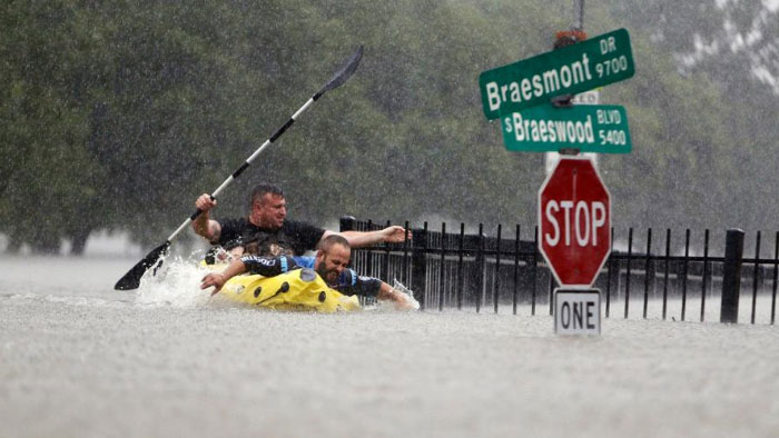 Two Kayakers Try To Beat The Current Pushing Them Down An Overflowing Brays Bayou From Tropical Storm Harvey In Houston