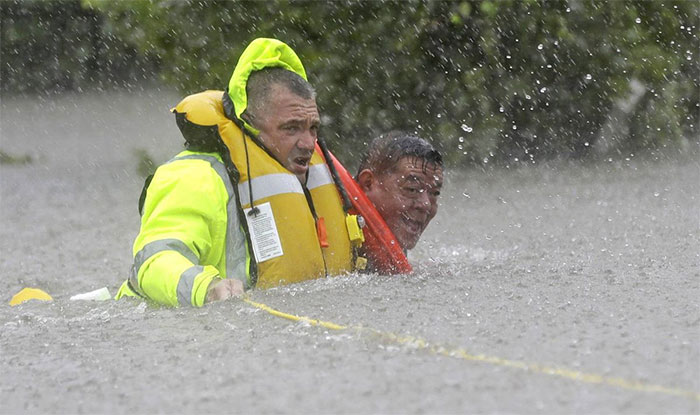 Wilford Martinez, Right, Is Rescued From His Flooded Car By Harris County Sheriff's Department Richard Wagner Along Interstate 610