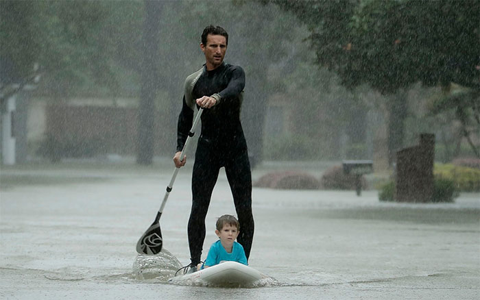 Alexendre Jorge Evacuates Ethan Colman, 4, From A Neighborhood Inundated By Floodwaters From Tropical Storm Harvey On Monday