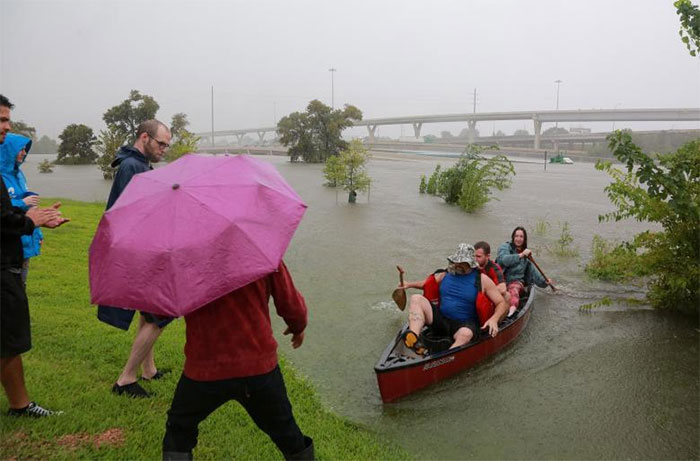 Area Residents Use A Kayak To Rescue Motorists Stranded On Interstate Highway 45 In Houston
