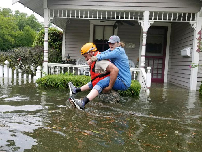 A Texas National Guard Soldier Carries A Woman On His Back As They Conduct Rescue Operations In Flooded Areas Around Houston