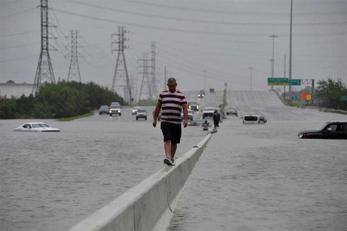 A Stranded Motorist Escapes Floodwaters On Interstate 225 In Houston, Texas
