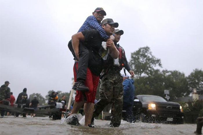 An Elderly Man Is Carried After Being Rescued In East Houston, Texas