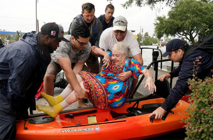 Sterling Broughton Is Moved From A Rescue Boat Onto A Kayak In Dickenson, Texas