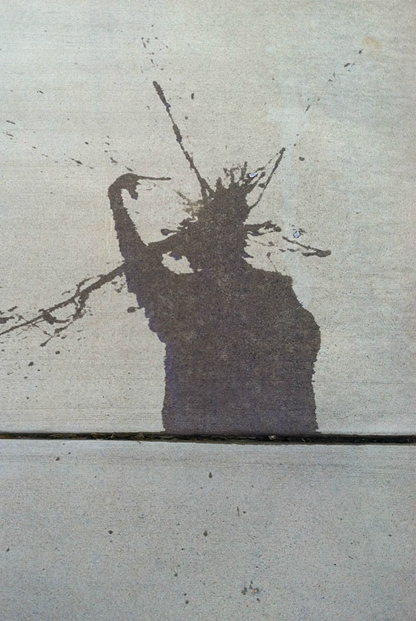 This Water Splash On This Driveway Looks Like The Statue Of Liberty Pointing At Her Head