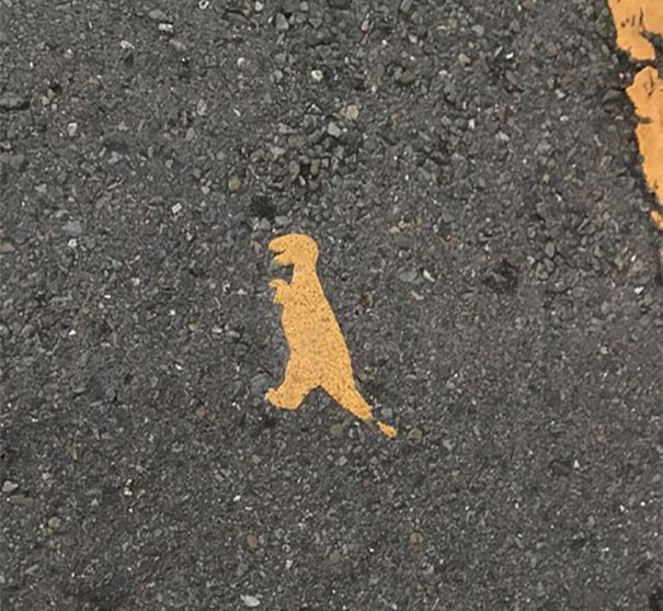 The Paint On This Crosswalk Looks Like A Dinosaur