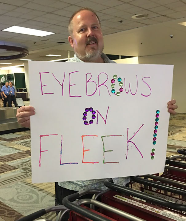 Man holding a greeting sign 