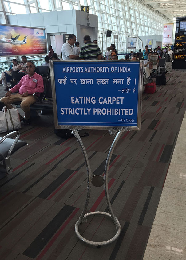 Airport sing that says "Eating Carpet Strictly Prohibited"