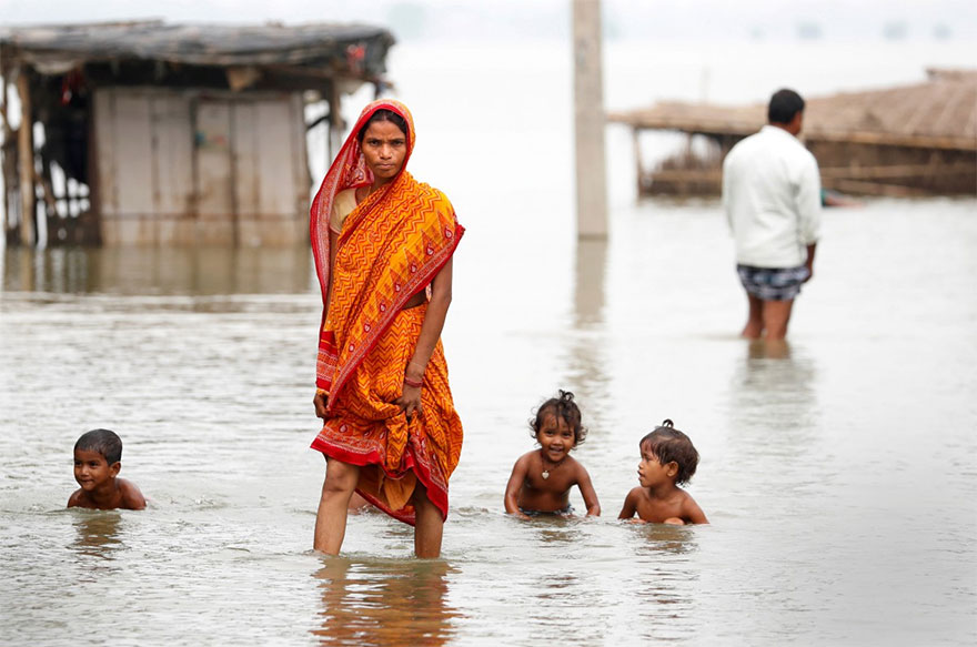A Woman Walks Through A Flooded Village In Motihari, Bihar State, India