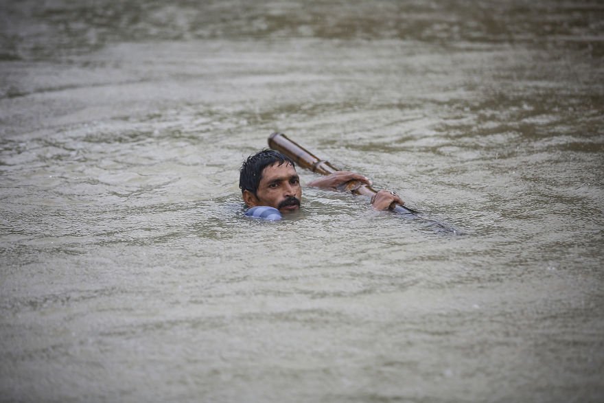 A Nepali Man Tries To Cross Flood Water At Topa Village In Saptari District