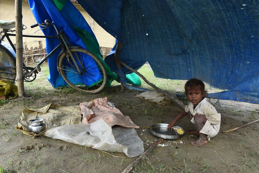 A Child Eats At A Makeshift Flood Shelter In Gaur, About 200 Km South Of Kathmandu, The Nepali Capital