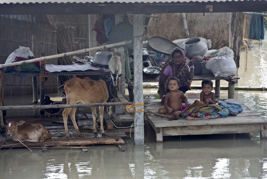 Flood Victims Wait For Relief Supplies In A Village East Of Gauhati In The Northeastern Indian State Of Assam