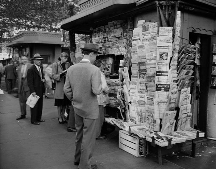 People Browsing Through Magazine Racks At A Busy Sidewalk Newsstand, 1947