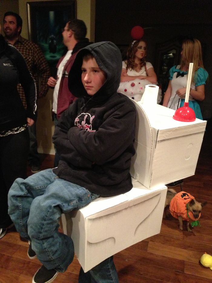A Child Is Wearing A Child-Sitting-On-Toilet Costume On A Halloween Party