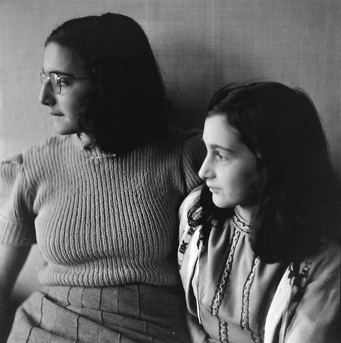 Black and white photography of Anne Frank with her sister