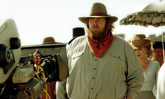 Photo of John Candy on the set of the film "Wagon East"