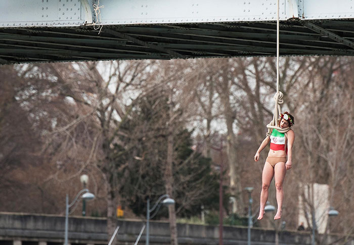 A Femen Activist, Sarah Constantin, Is Hanged From A Noose-Like Rope From A Paris Bridge To Call Attention To The Large Number Of Executions In Iran. Paris, 28 January 2016