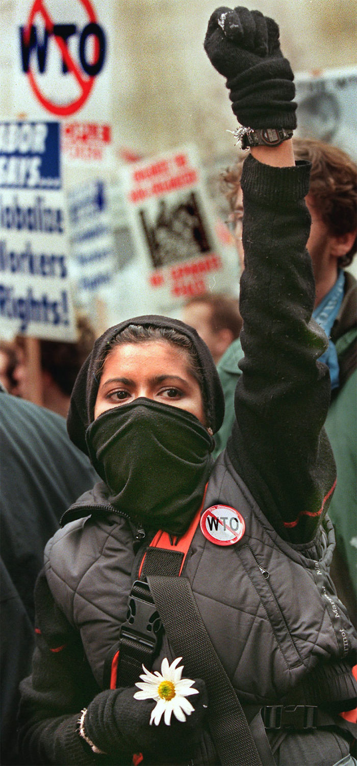 A Demonstrator Holds A Flower That She Says Is A Symbol Of Hope, 3 December 1999