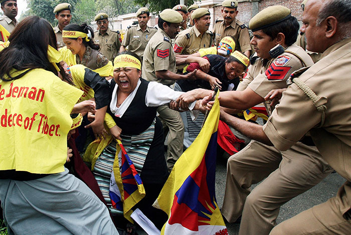Indian Policemen Restrain A Tibetan Woman During A Demonstration At The Chinese Embassy. On The Occasion Of The Tibetan Women’s Uprising Day, New Delhi, 12 March 2008
