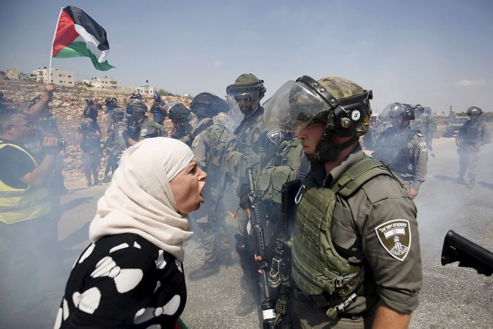A Palestinian Woman Argues With An Israeli Border Policeman During A Protest Against Jewish Settlements In The West Bank Village Of Nabi Saleh