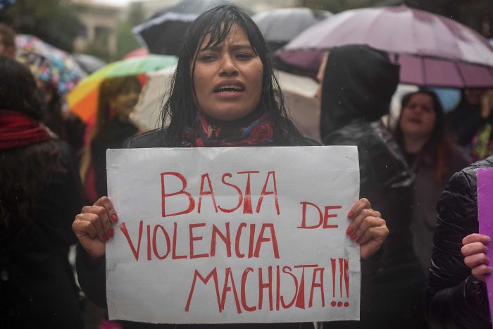 A Woman In Buenos Aires Protests With A Sign That Says “Stop Sexist Violence”