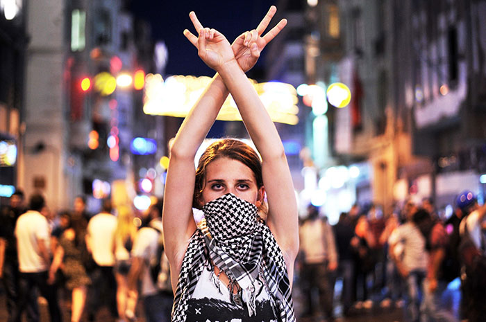 An Anti Government Protester Flashes A Victory Sign During The Clashes Between Protesters And Riot Police On Taksim Square In Istanbul, 22 June 2013