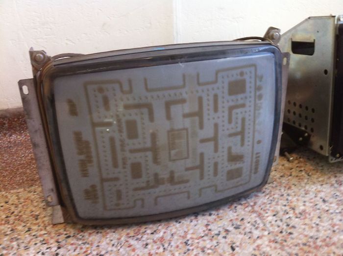 An Old CRT TV Screen That Has Seen A Lot Of Pacman