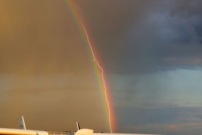 Rayo cayendo sobre un avión mientras volaba por un arco iris
