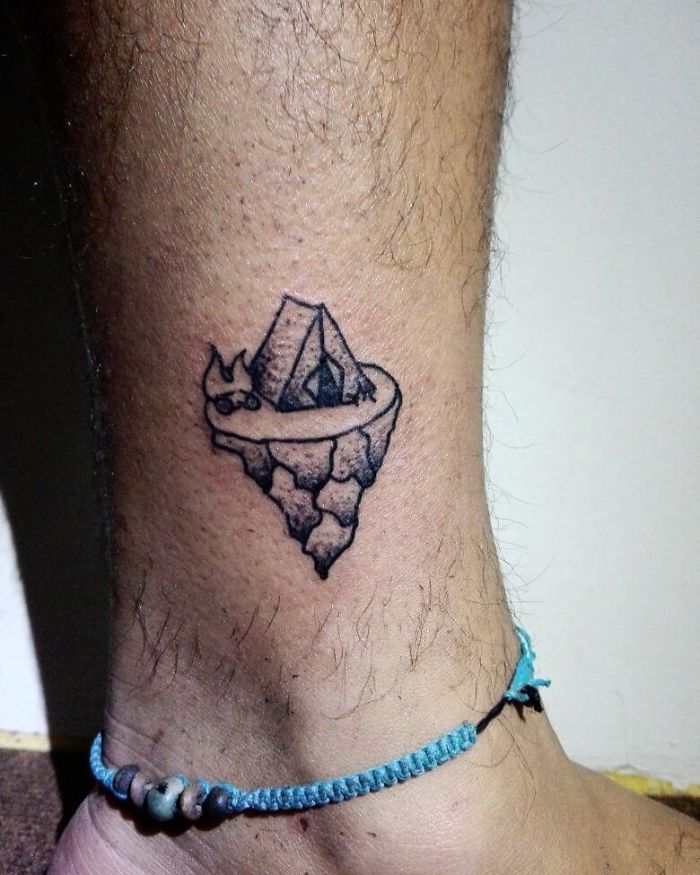 Tent with fire ankle tattoo