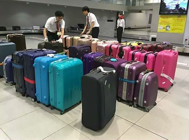 Japanese Airport Staff Sorted Luggages On The Belt By Their Colour