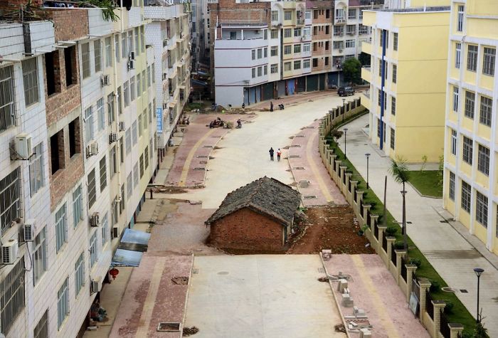 A Nail House Sits In The Middle Of A Road Under Construction In Nanning, China, In April 2015. The Owner Of The House Didn’t Reach An Agreement With The Local Authority About Compensation For The Demolition
