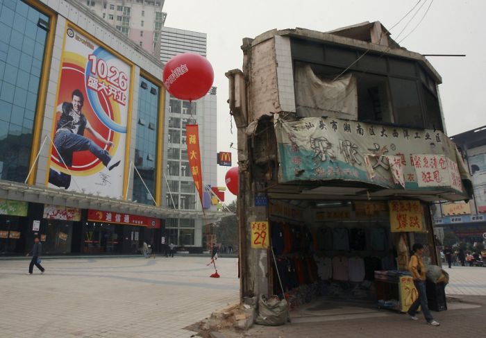 The Last House In This Area Stands In Front Of A Shopping Mall In Central China's Hunan Province