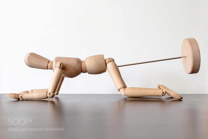 Wooden drawing mannequin placed in a doggy position