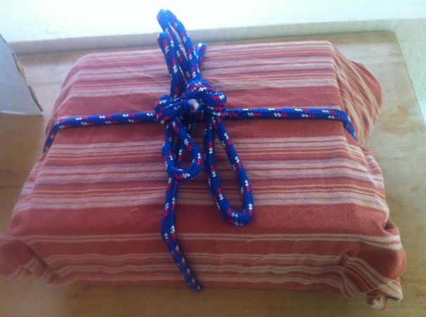 This Is How My Husbands Wraps Gifts. That Is An Old Tablecloth And Rope... He Said "What? I'm Going Green"